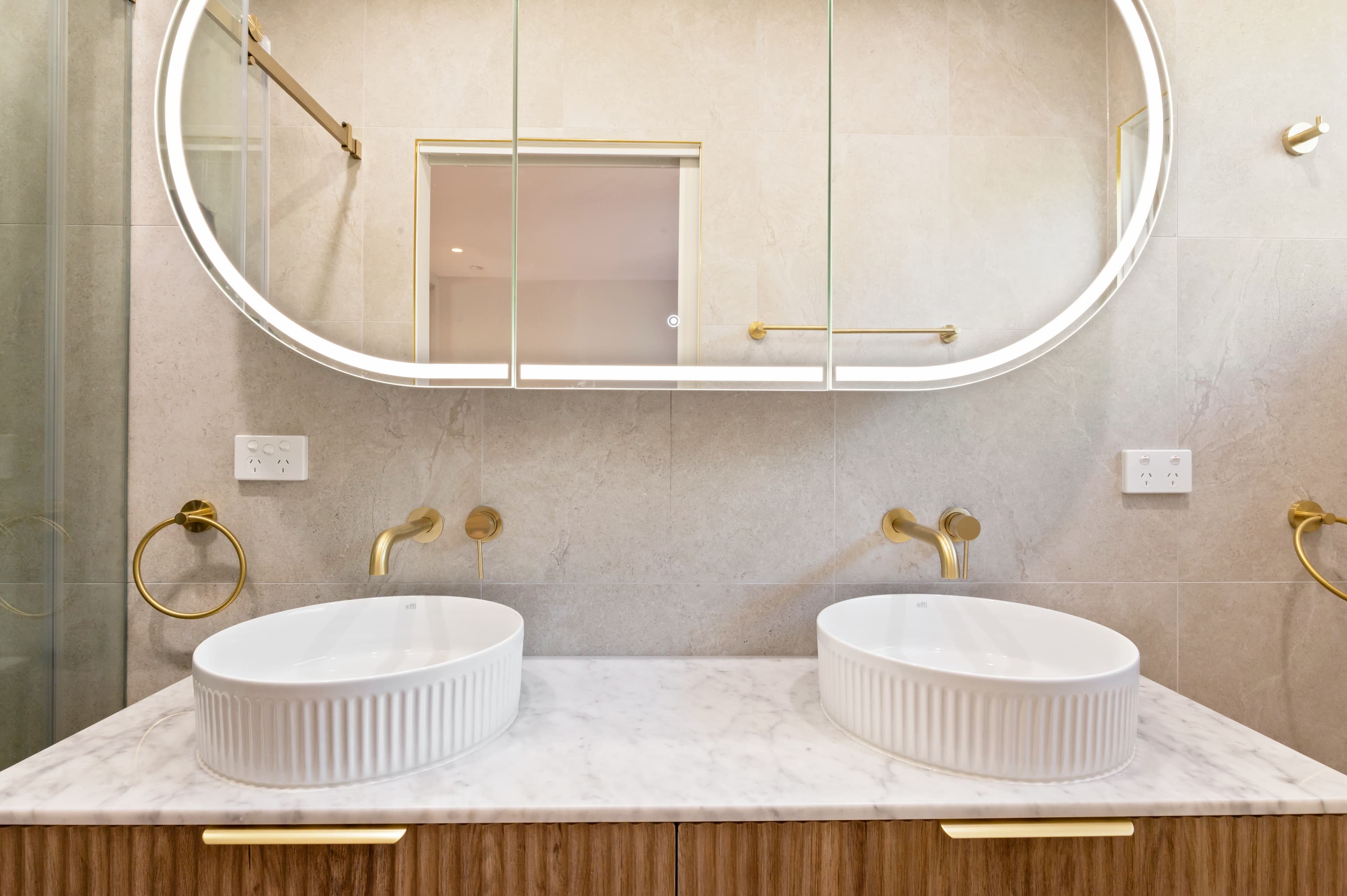 Close-up of a contemporary vanity basin and shaving cabinet, showcasing elegant fixtures and organized space